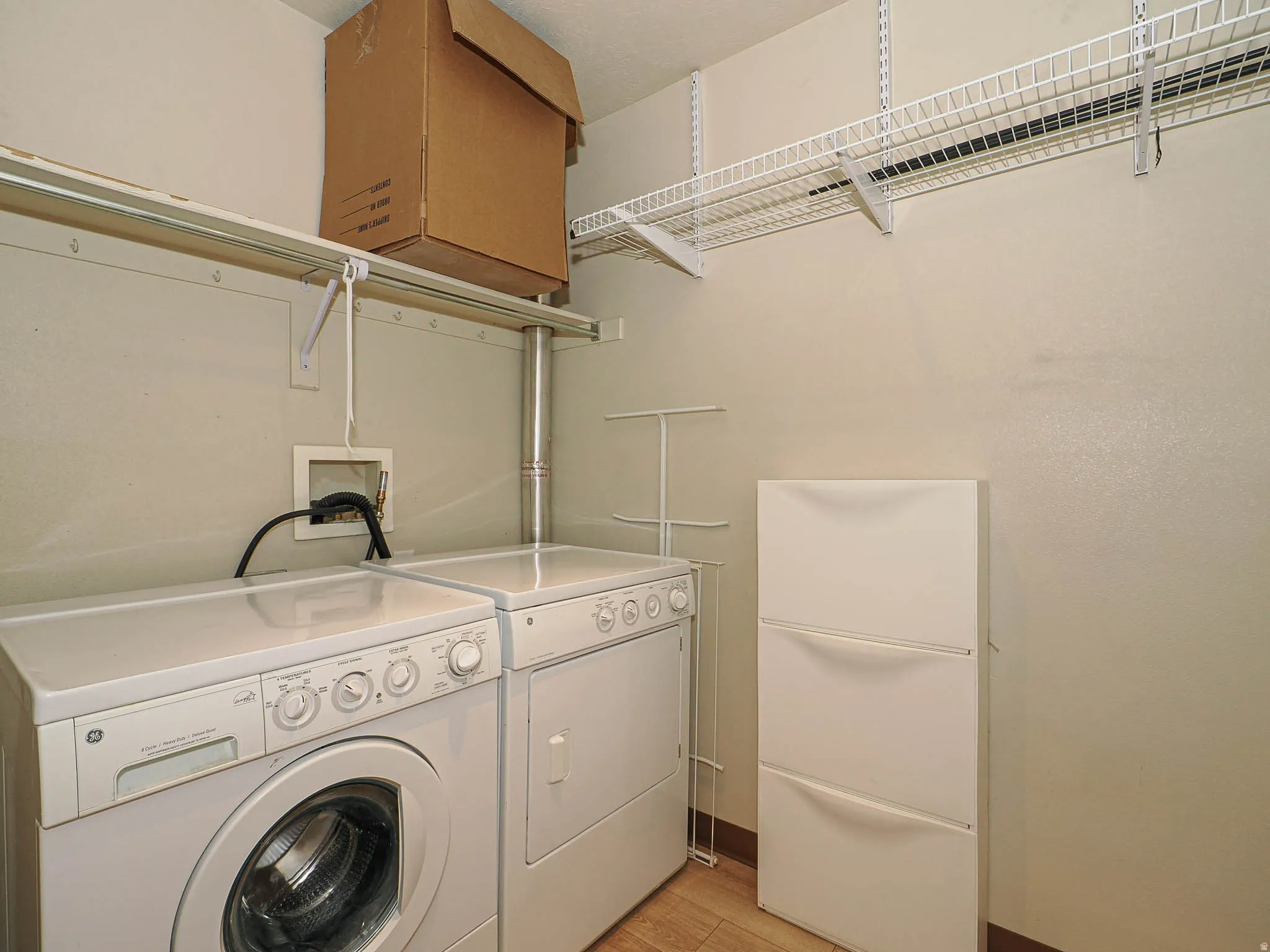 Laundry room featuring light wood-style flooring and washer and dryer