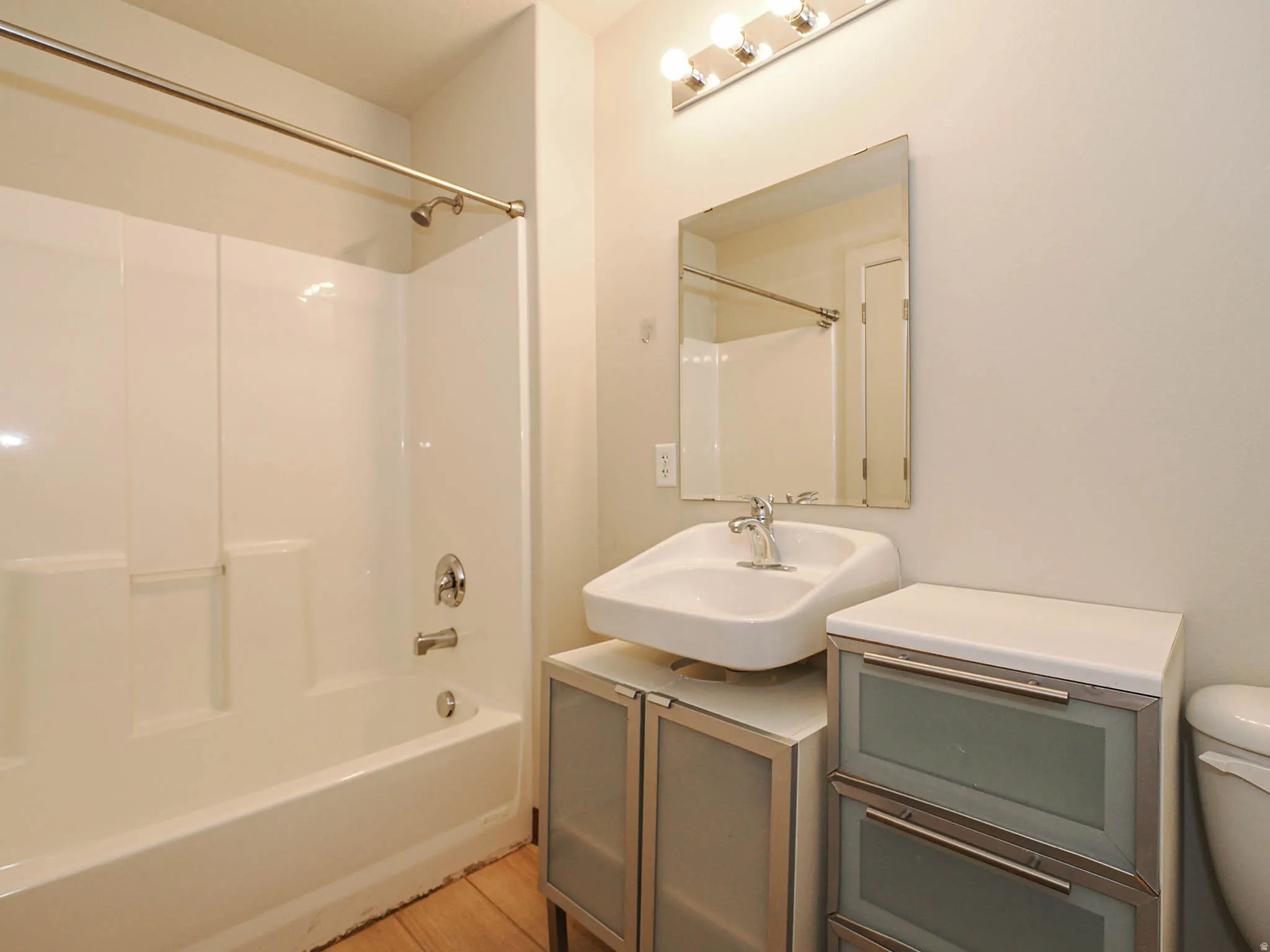 Bathroom with vanity and bathtub / shower combination