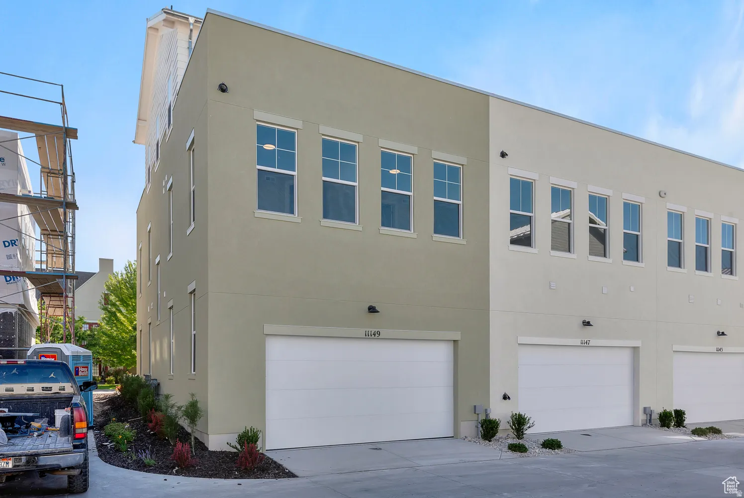 View of property exterior with a garage and stucco siding