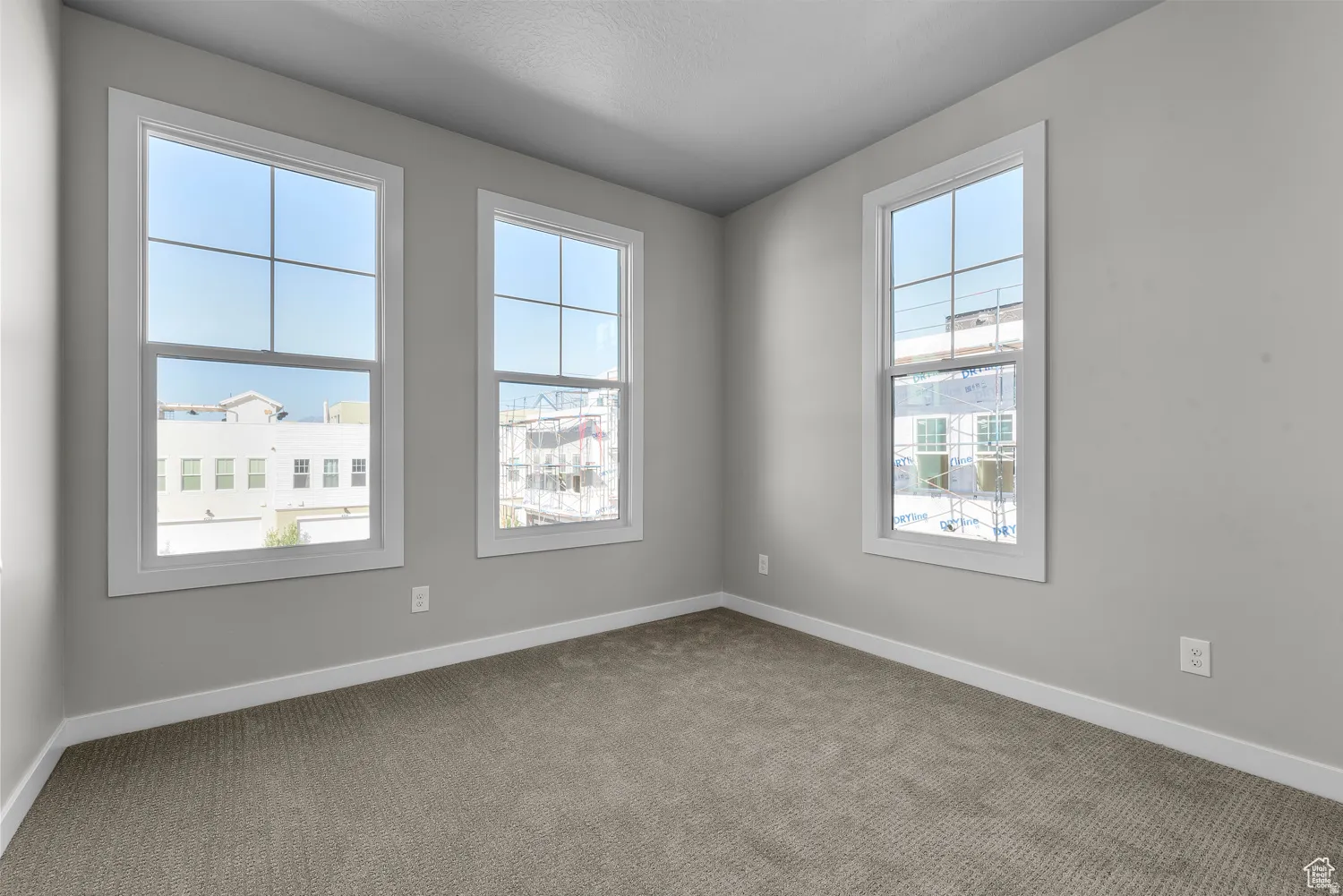 Empty room with carpet flooring and baseboards