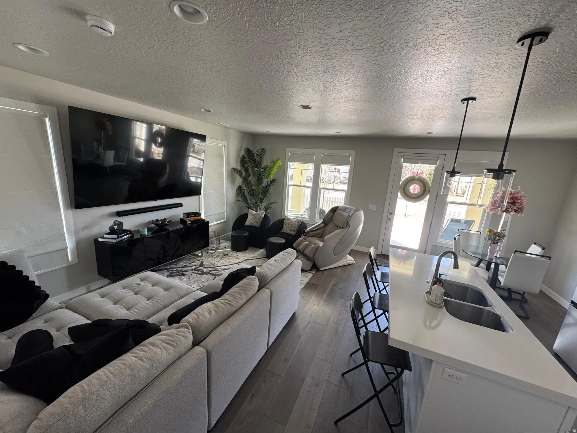 Living room with dark wood finished floors and a textured ceiling