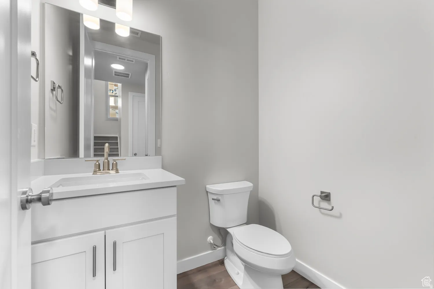 Bathroom featuring vanity and dark wood-style floors