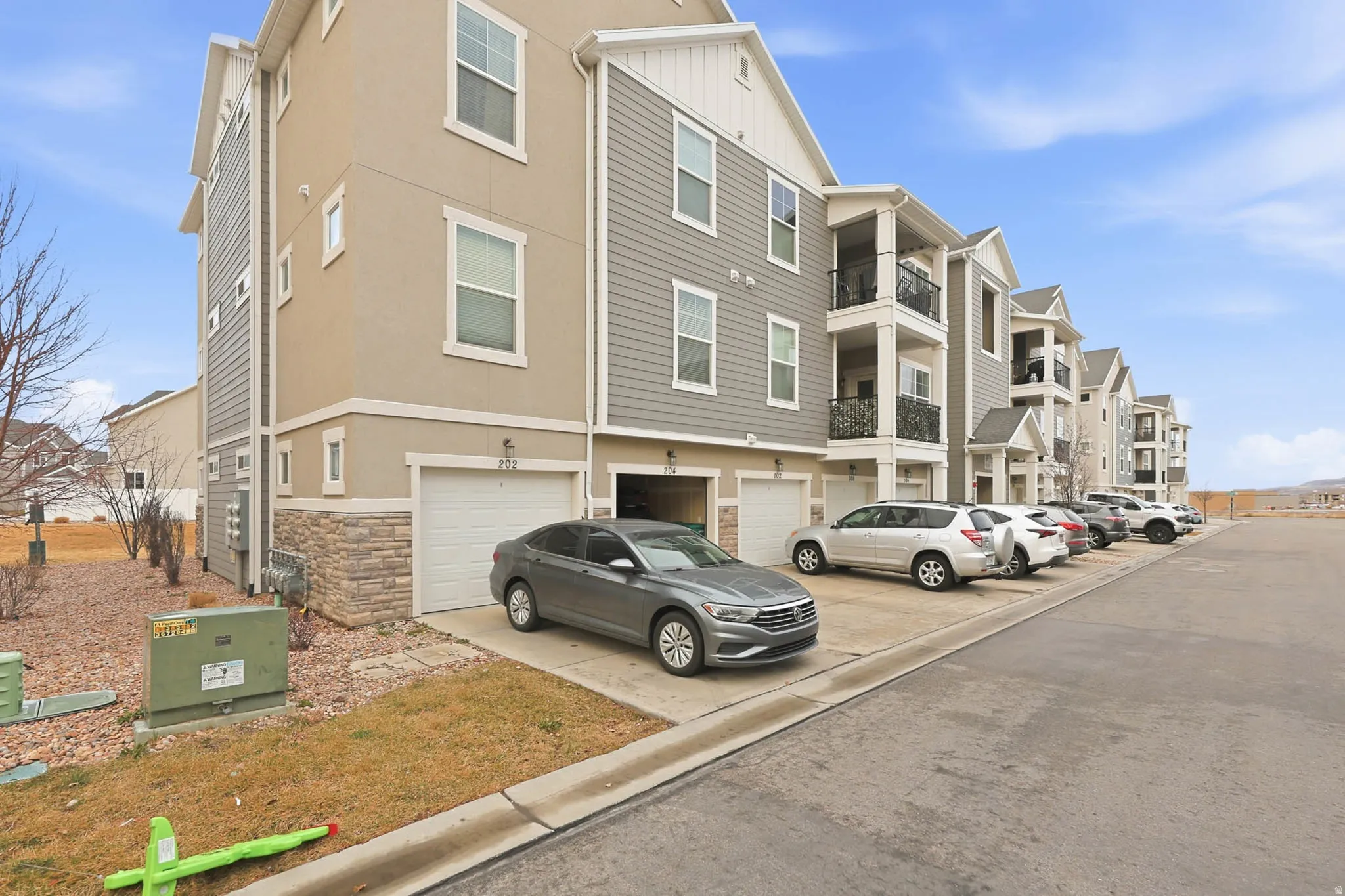 View of property featuring a garage and driveway