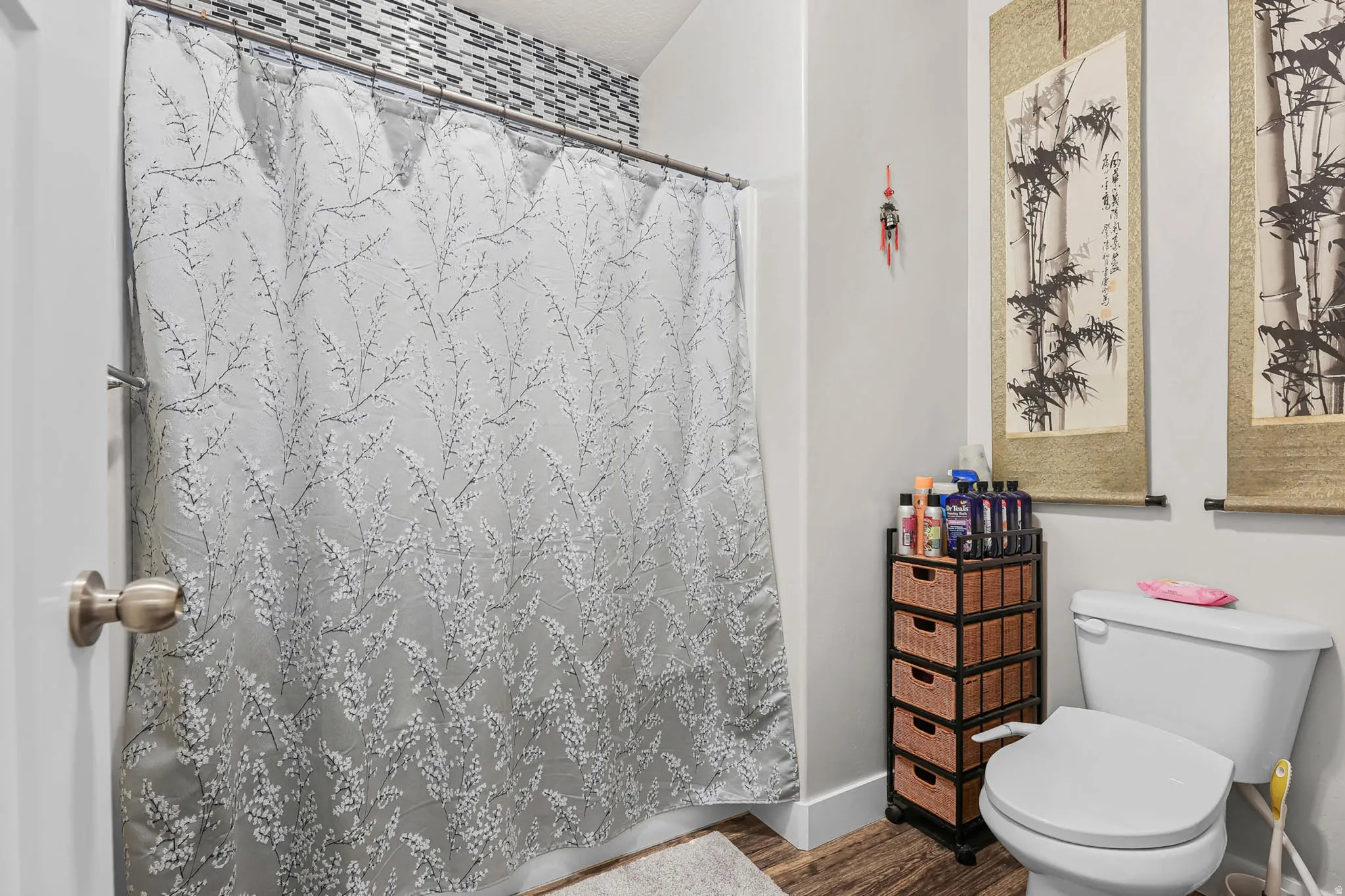Full bath featuring toilet and dark wood-style flooring