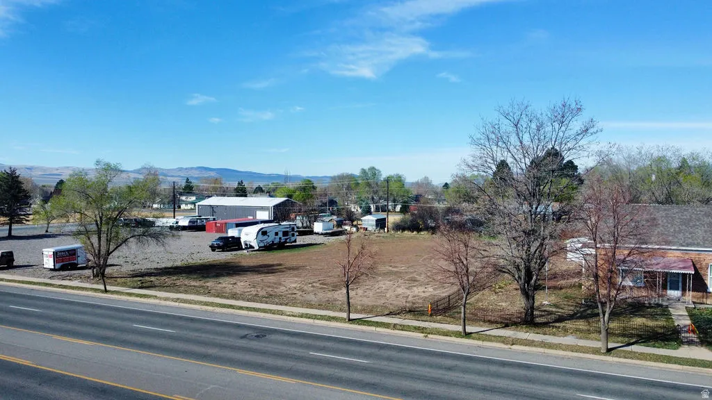 View of asphalt street featuring sidewalks and a mountain view