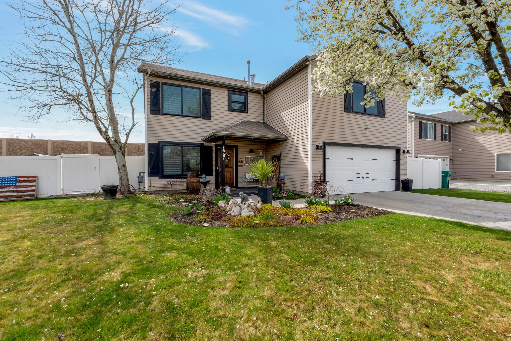 Traditional-style house with an attached garage and driveway