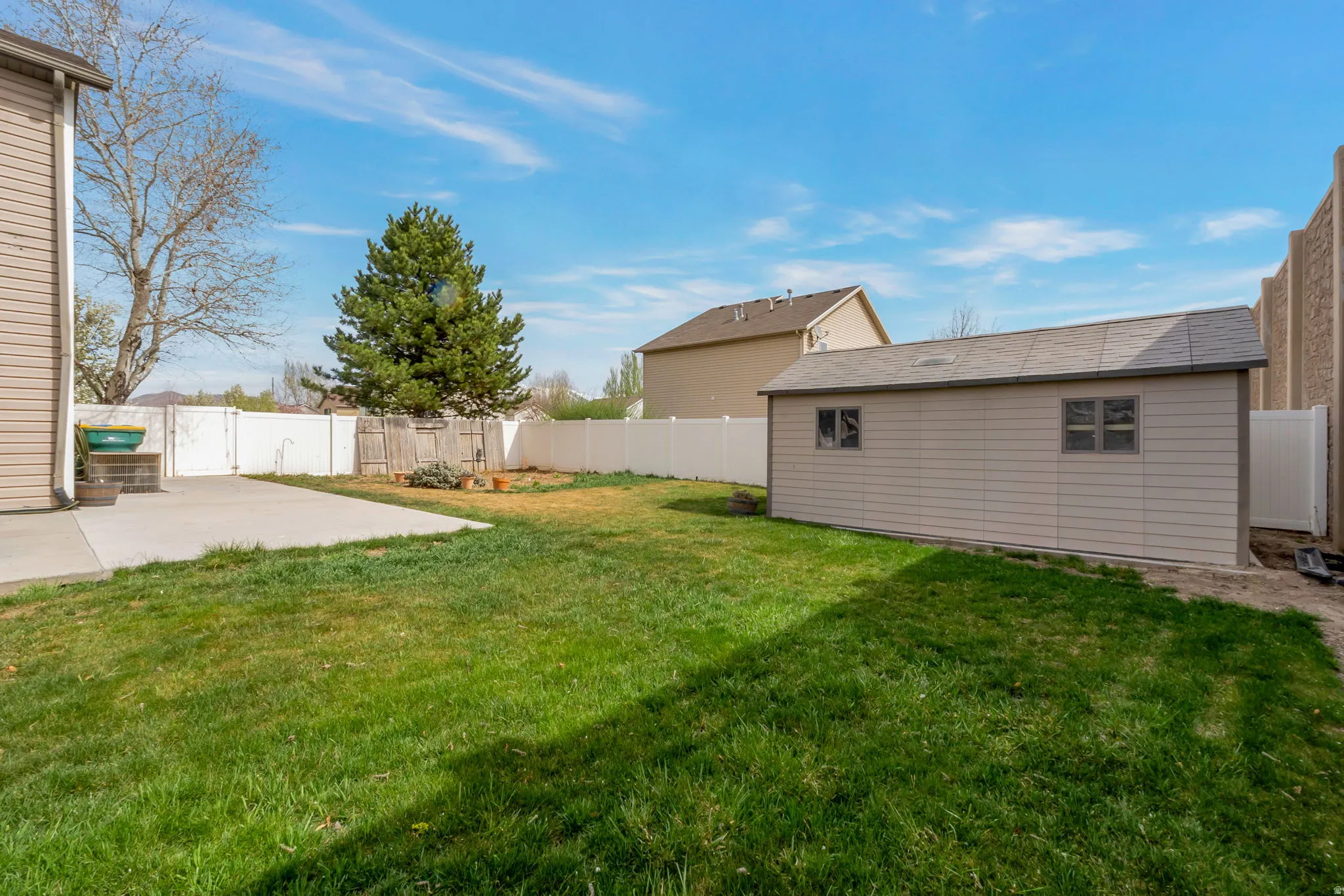 Fenced backyard featuring a patio