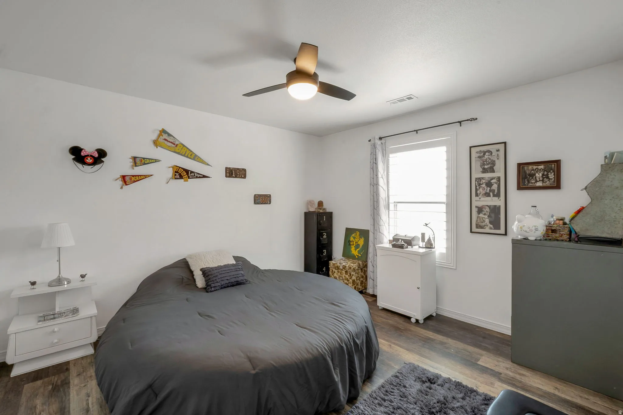 Bedroom with dark wood finished floors and ceiling fan