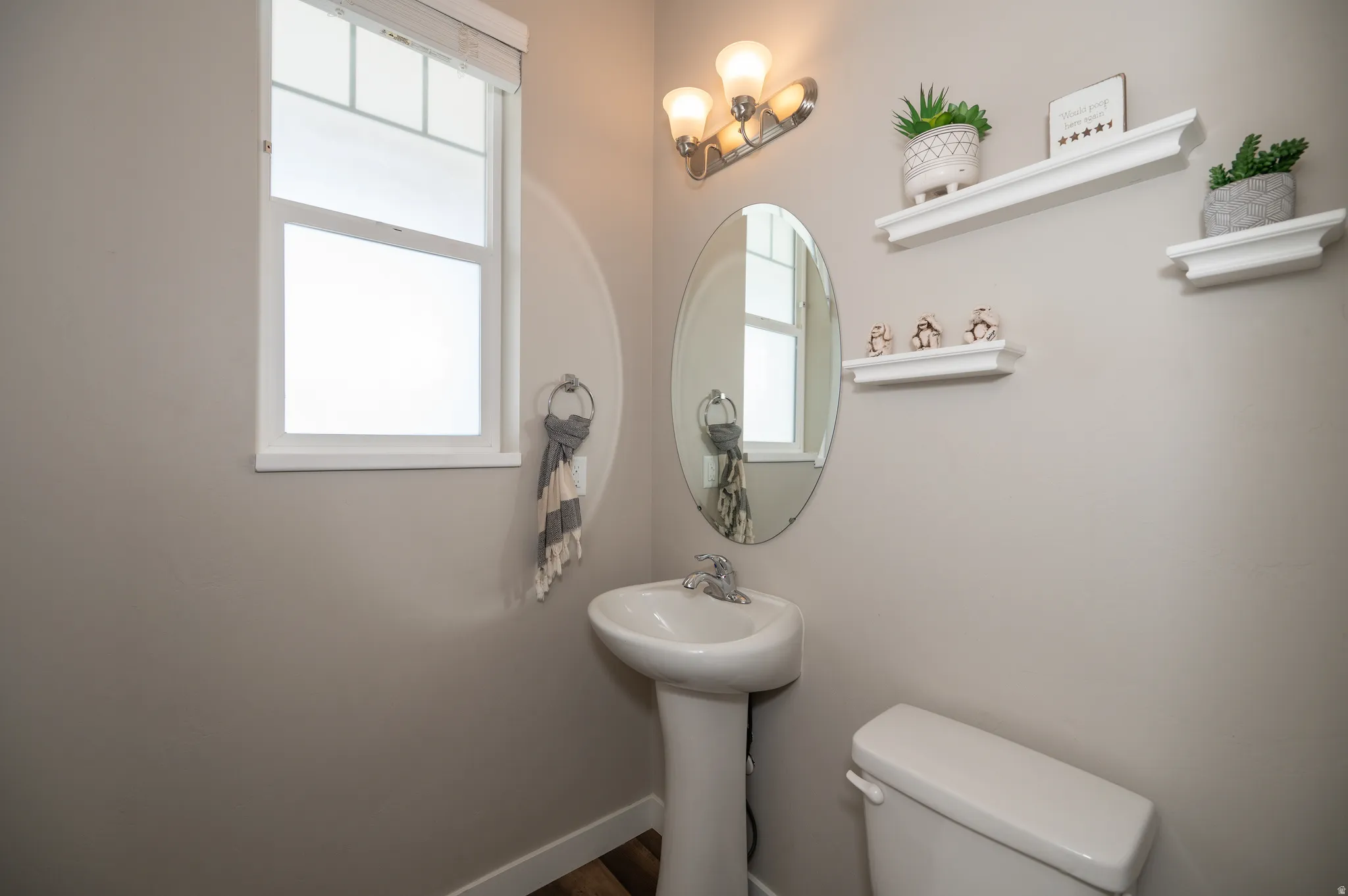 Half bath with toilet and baseboards