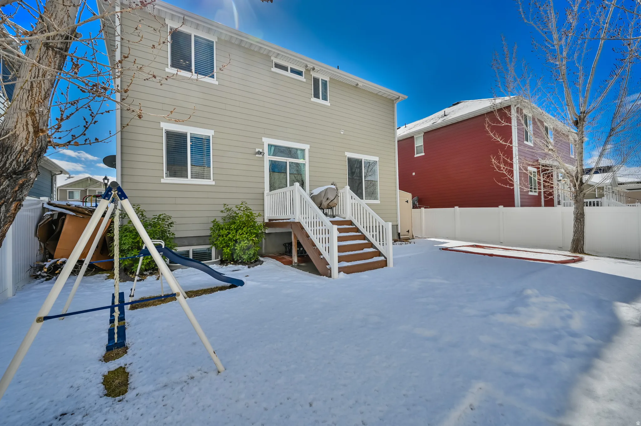 View of snow covered rear of property