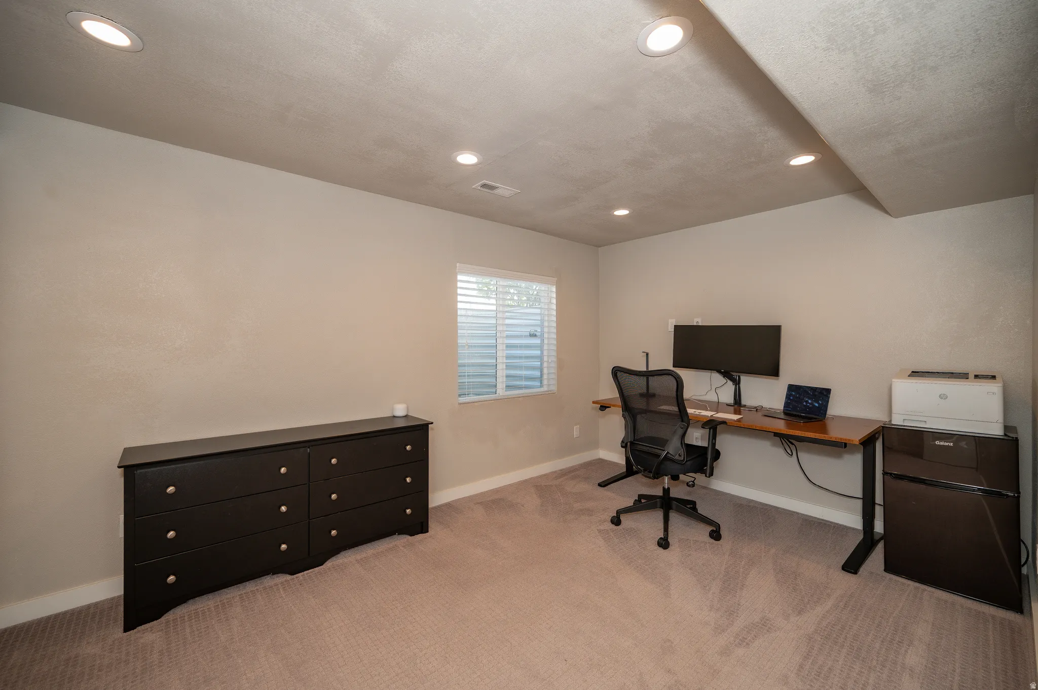 Home office featuring light colored carpet and recessed lighting
