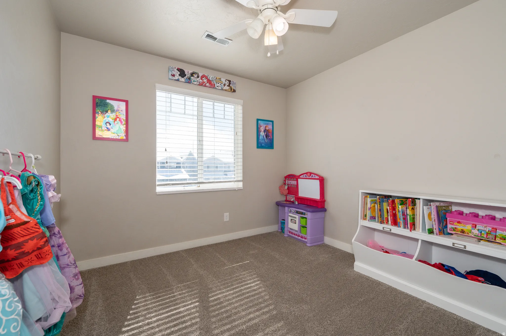 Game room featuring a ceiling fan and dark carpet