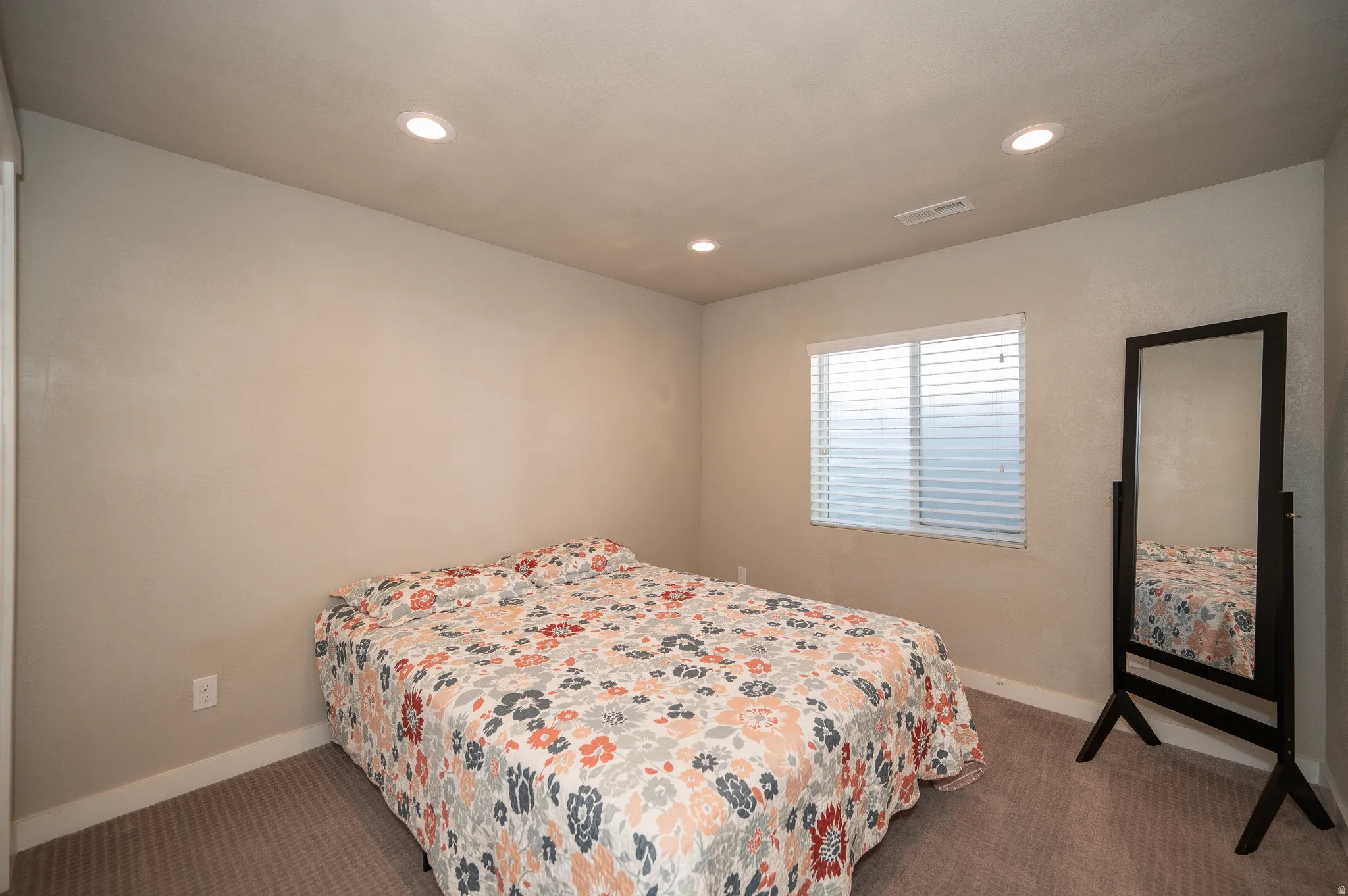 Bedroom featuring dark carpet and recessed lighting