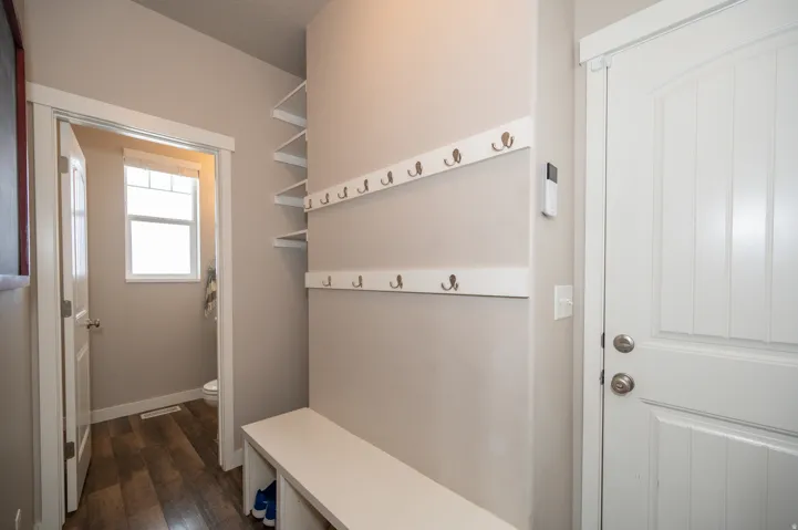 Mudroom with dark wood finished floors and baseboards