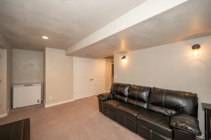 Living area featuring carpet floors and a textured ceiling