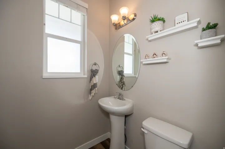 Half bath with toilet and baseboards
