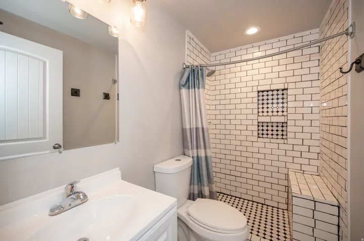 Bathroom with vanity, a stall shower, and recessed lighting