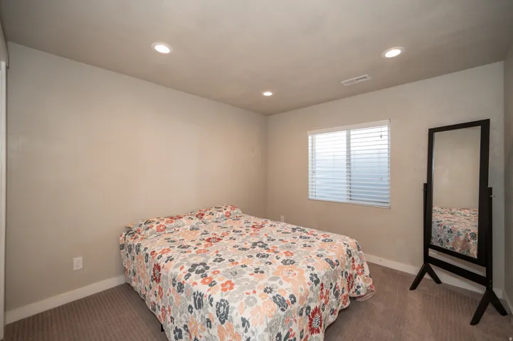 Bedroom featuring dark carpet and recessed lighting