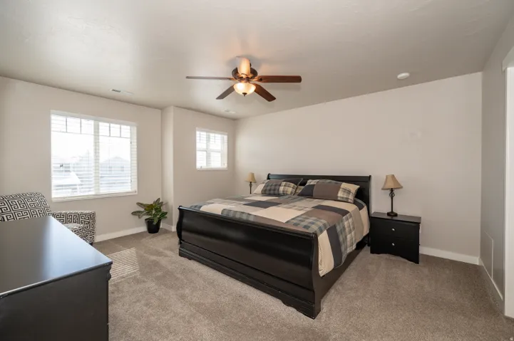 Bedroom featuring light carpet and ceiling fan