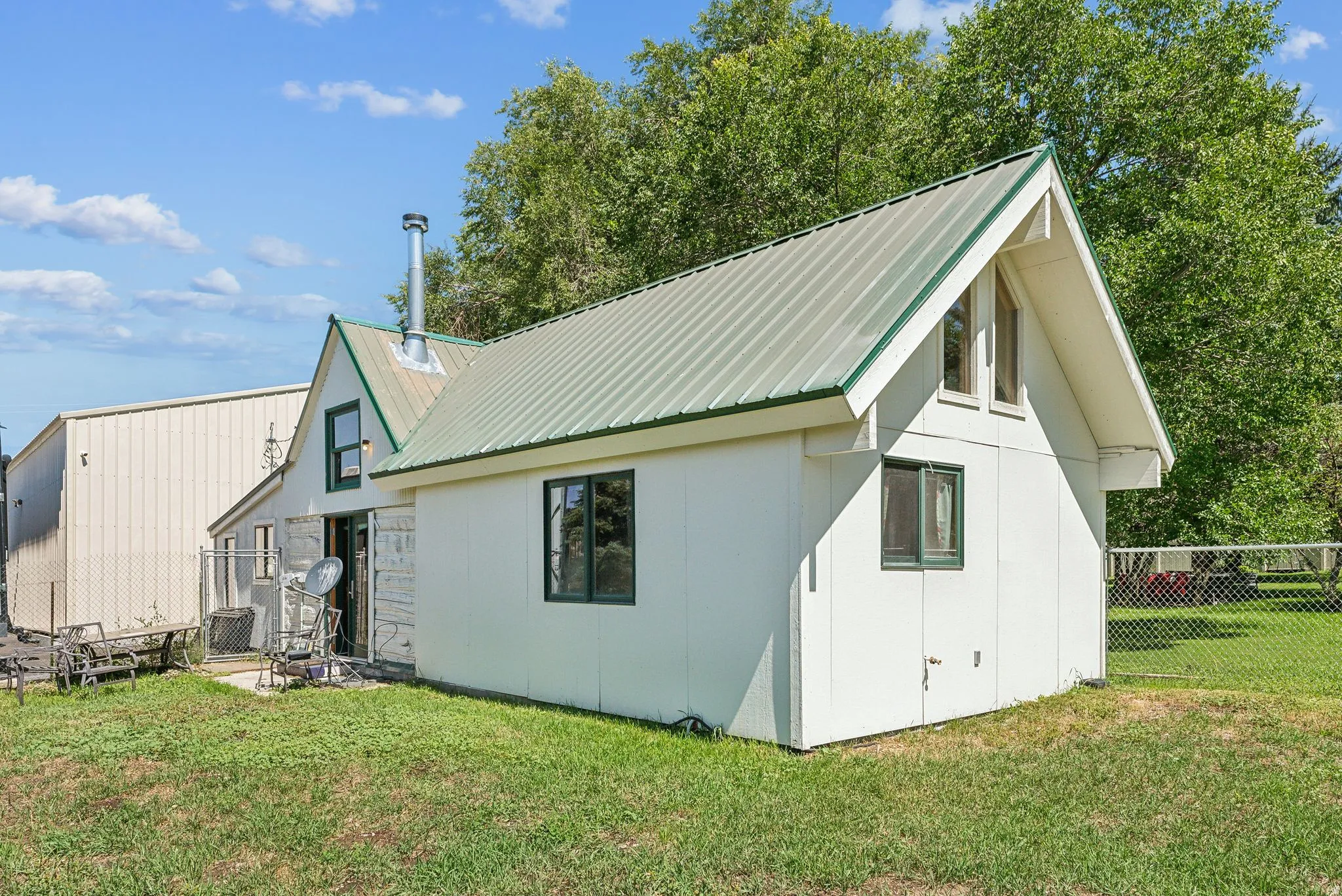 Rear view of property with a metal roof