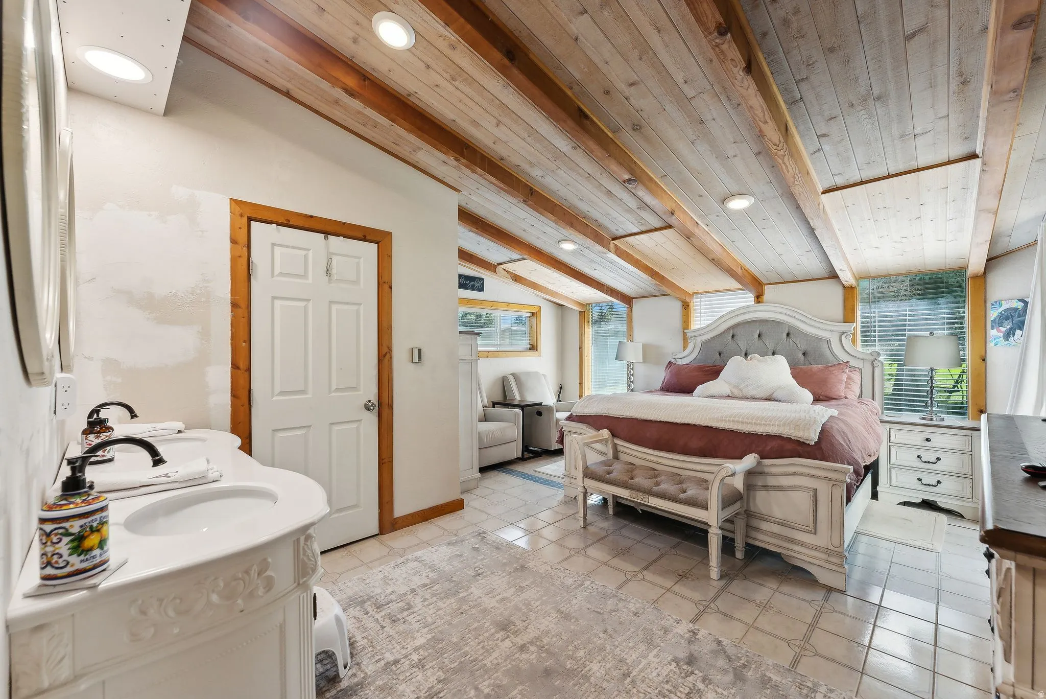 Bedroom with vaulted ceiling with beams, light tile patterned floors, and recessed lighting