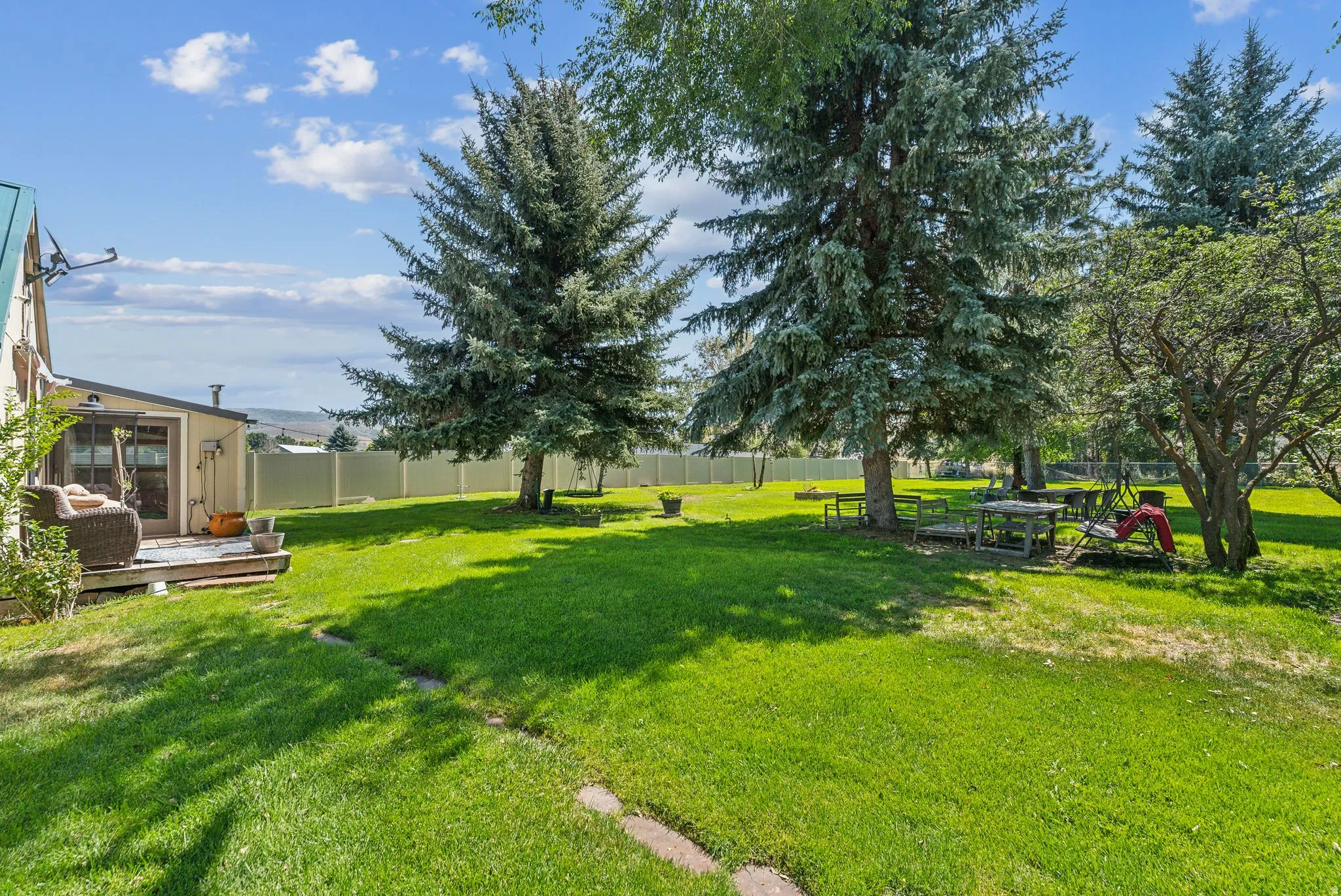 Fenced backyard with a deck