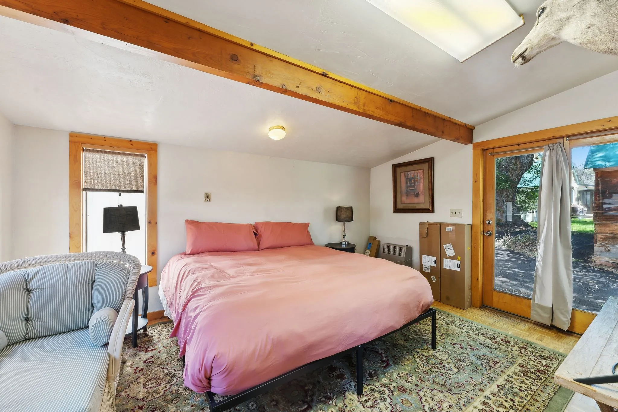 Bedroom featuring lofted ceiling with beams, access to outside, and parquet flooring