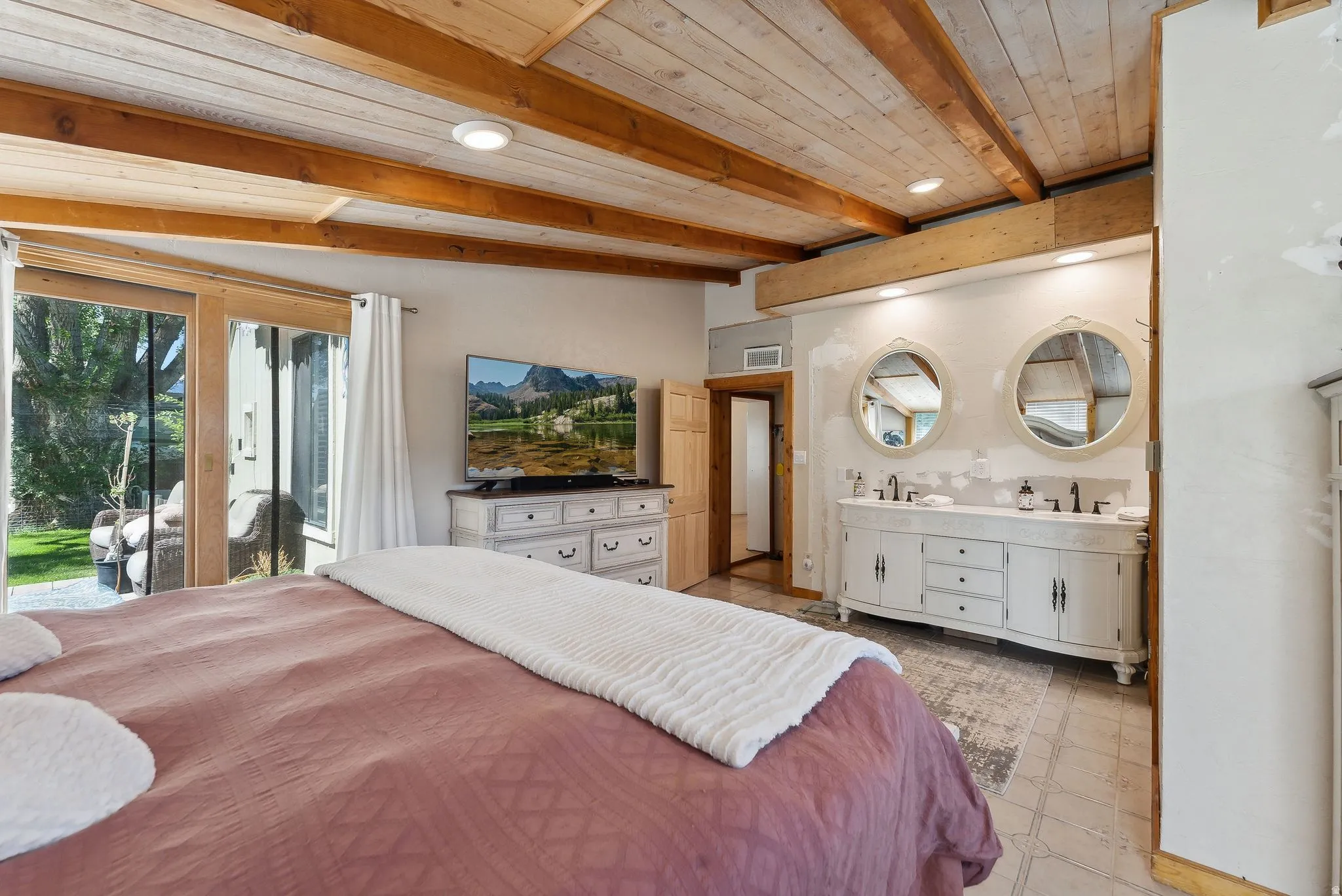 Bedroom with access to exterior, a wood ceiling with exposed beams, and recessed lighting
