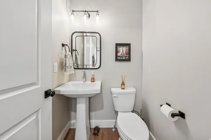 Bathroom with toilet and wood finished floors