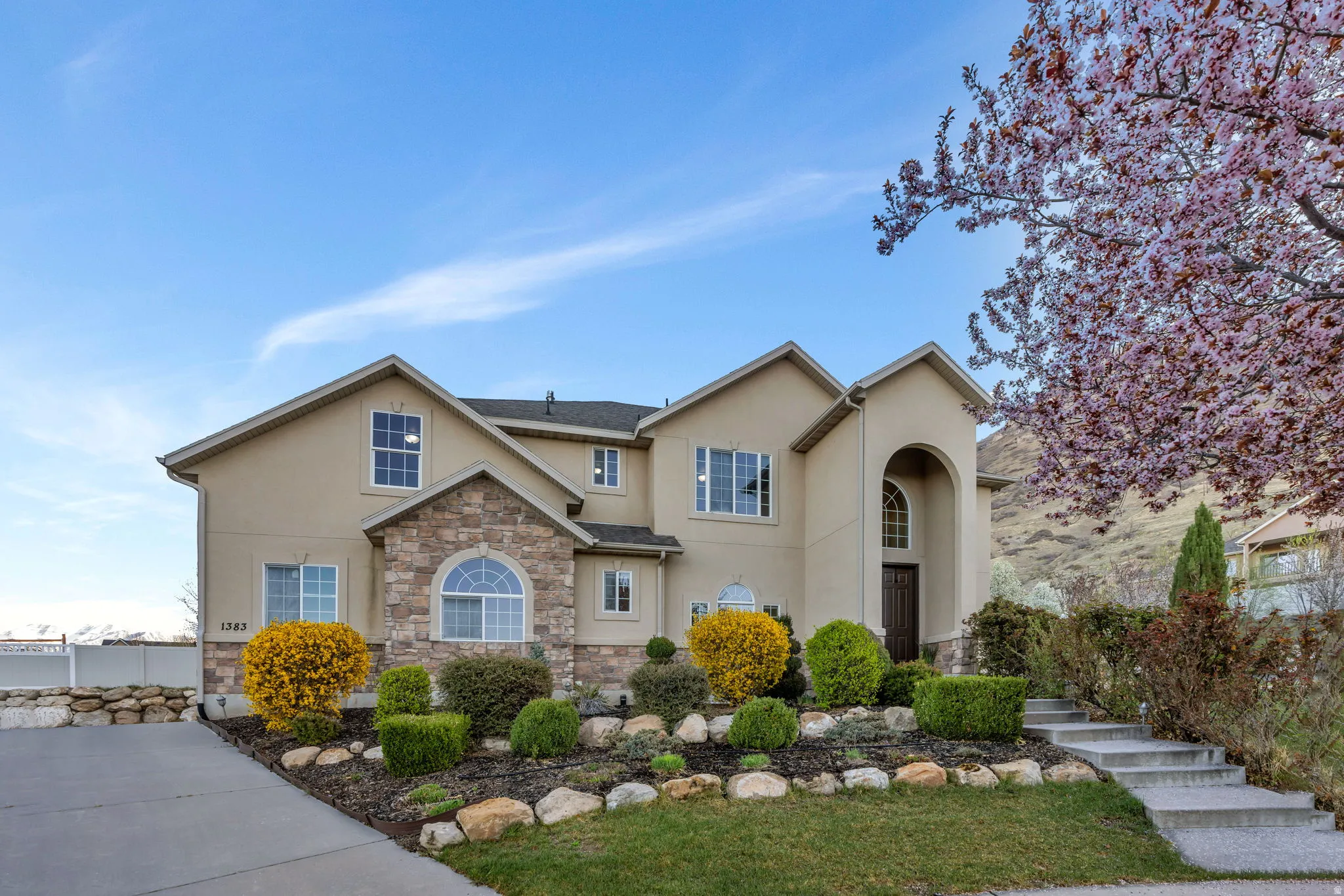 Traditional-style home featuring stone siding and stucco siding