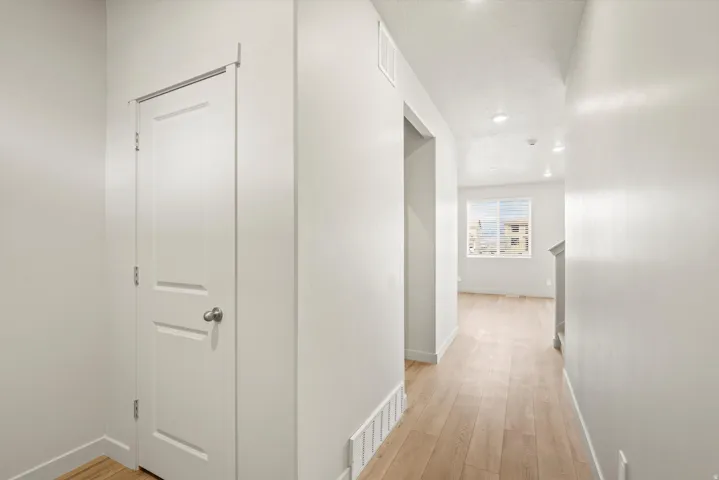 Hallway featuring light wood-style floors and recessed lighting