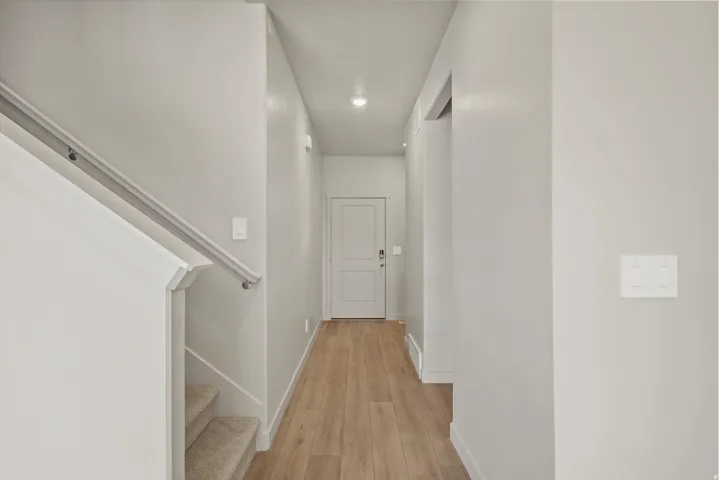 Hallway featuring light wood-style flooring and recessed lighting