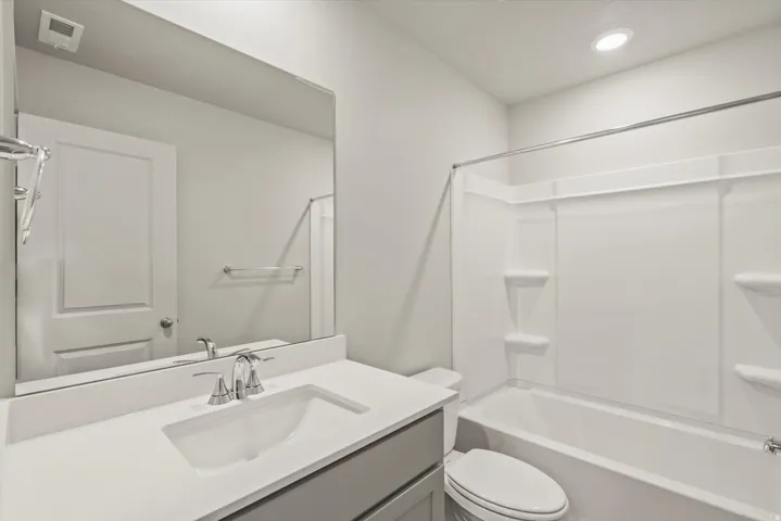Bathroom featuring vanity, washtub / shower combination, and recessed lighting