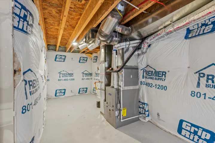 Unfinished below grade area featuring heating unit