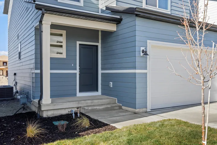 Doorway to property featuring a garage
