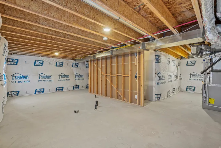 Unfinished basement featuring heating unit