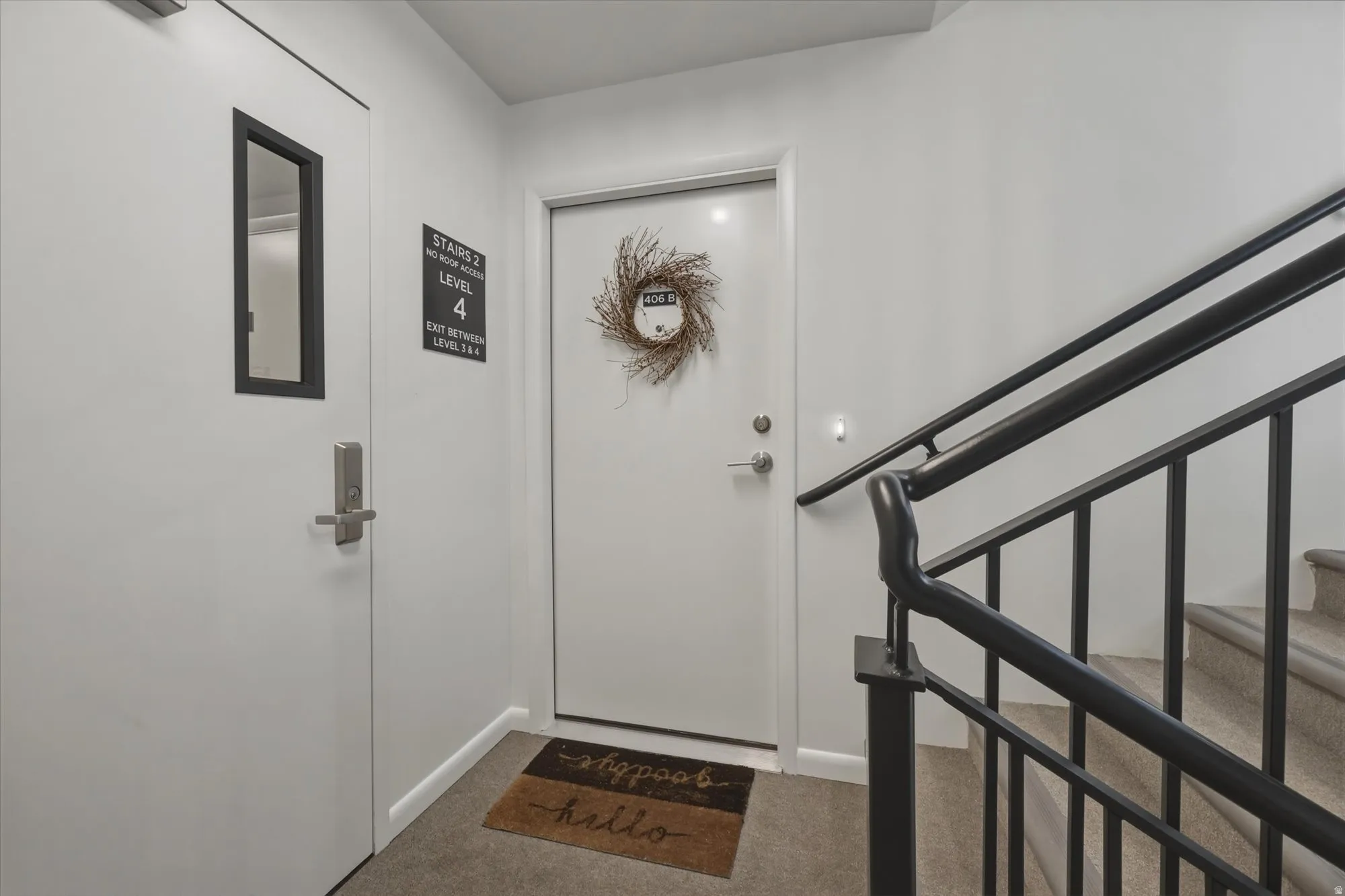 Entryway featuring stairs and light colored carpet