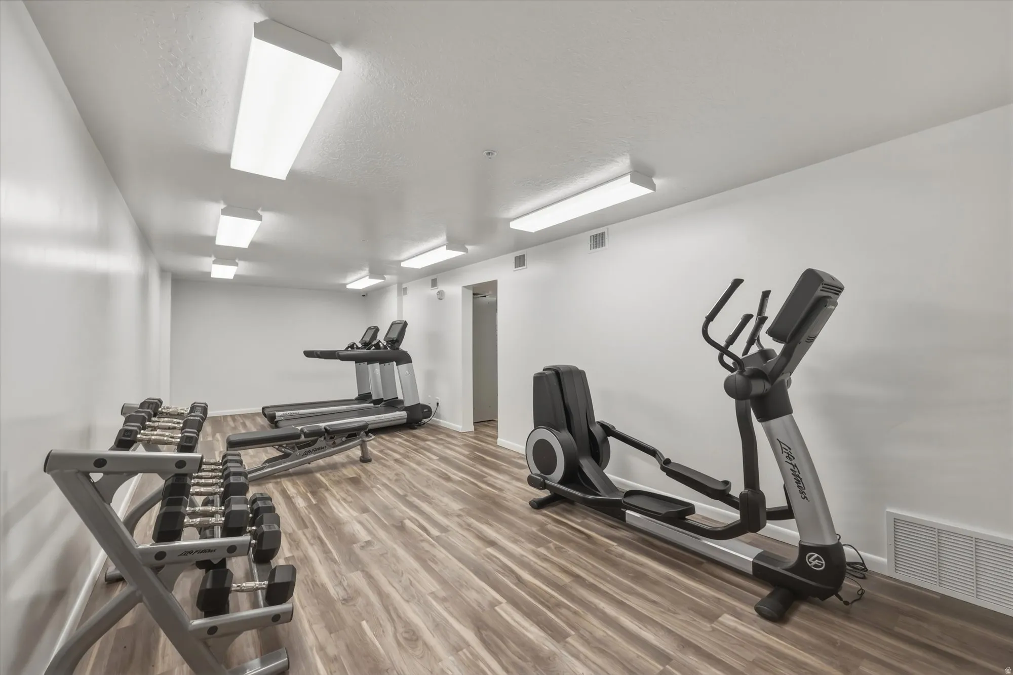 Exercise room with a textured ceiling