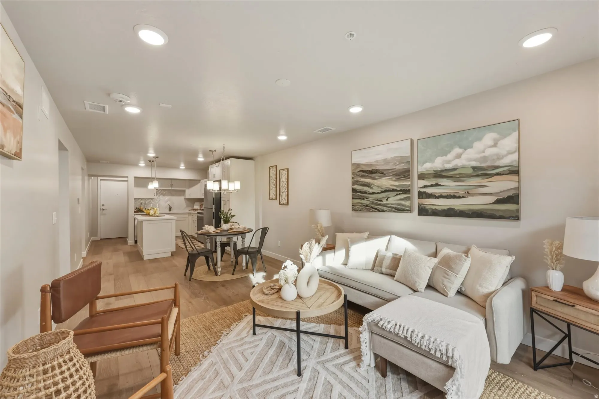 Living room with light wood-type flooring and recessed lighting