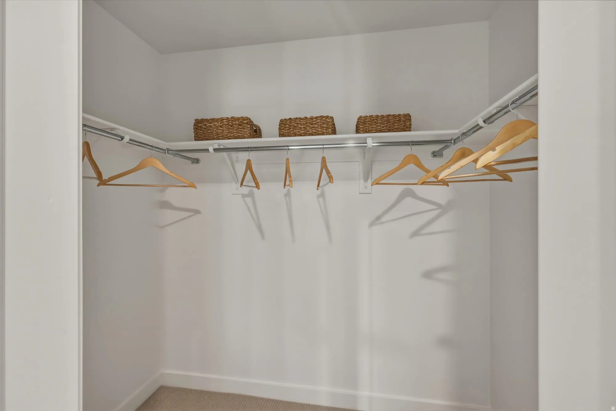 Walk in closet with carpet flooring