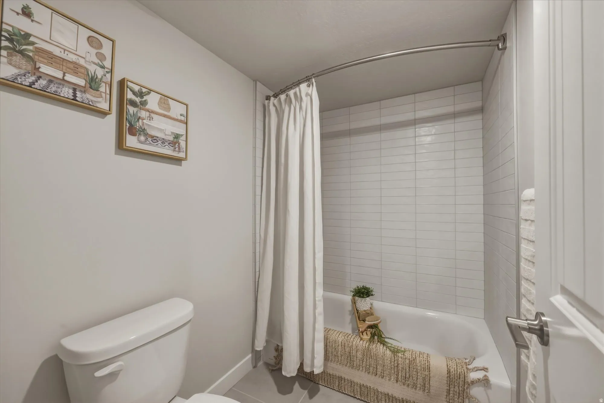 Bathroom featuring toilet and shower / bath combo