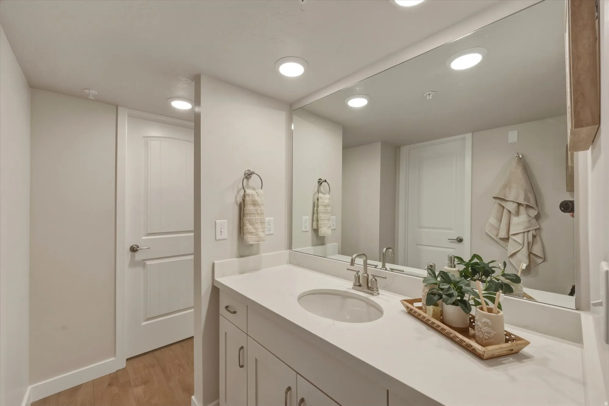 Bathroom featuring vanity, recessed lighting, and light wood finished floors