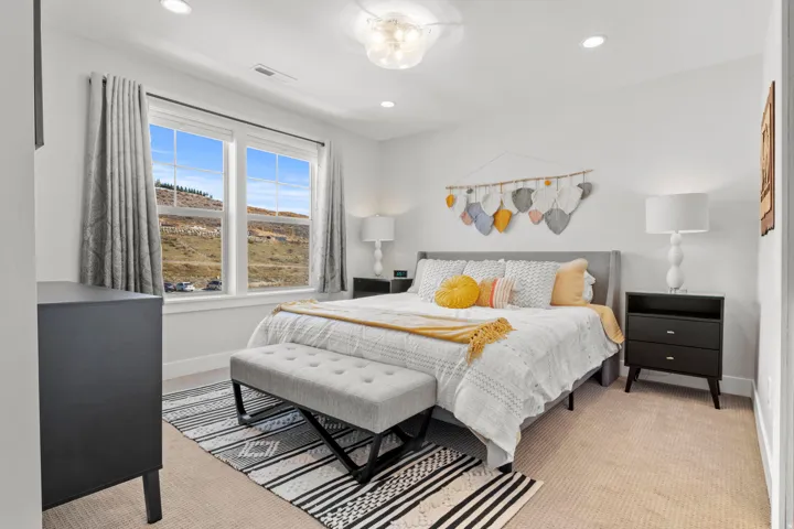 Bedroom with light carpet and recessed lighting