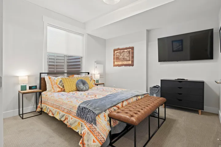 Bedroom featuring light carpet