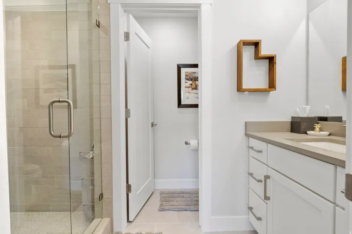 Bathroom featuring vanity, a shower stall, and light tile patterned floors