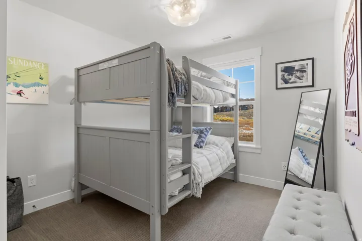 Bedroom with light colored carpet