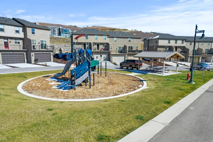 Community playground featuring a residential view and a lawn