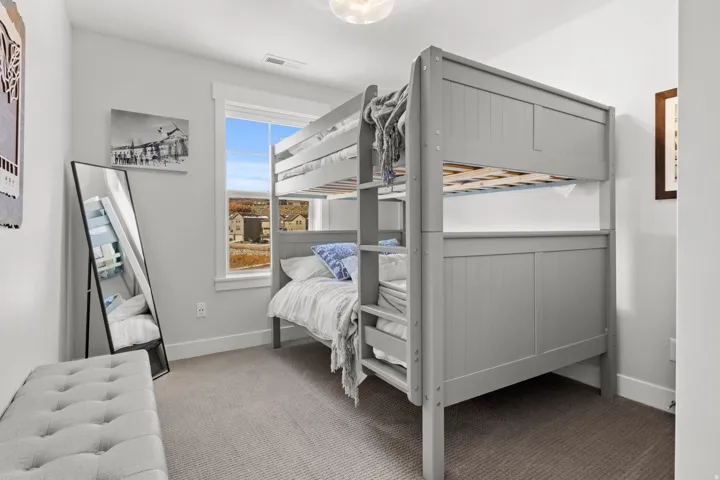 Bedroom with light carpet and baseboards