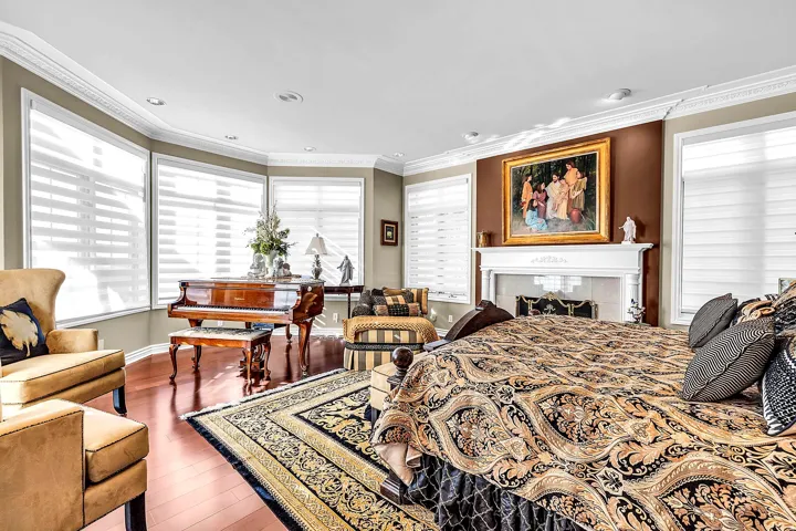 Bedroom featuring dark wood-style floors, ornamental molding, recessed lighting, and a tile fireplace