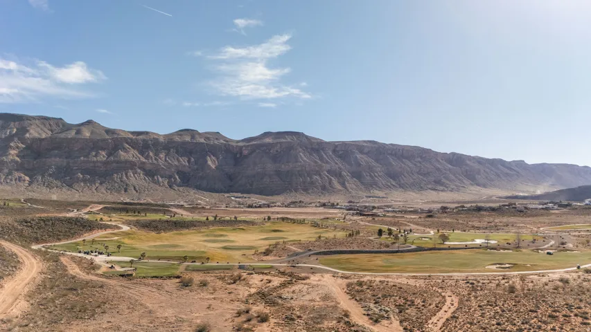 View of mountain background featuring a local golf course